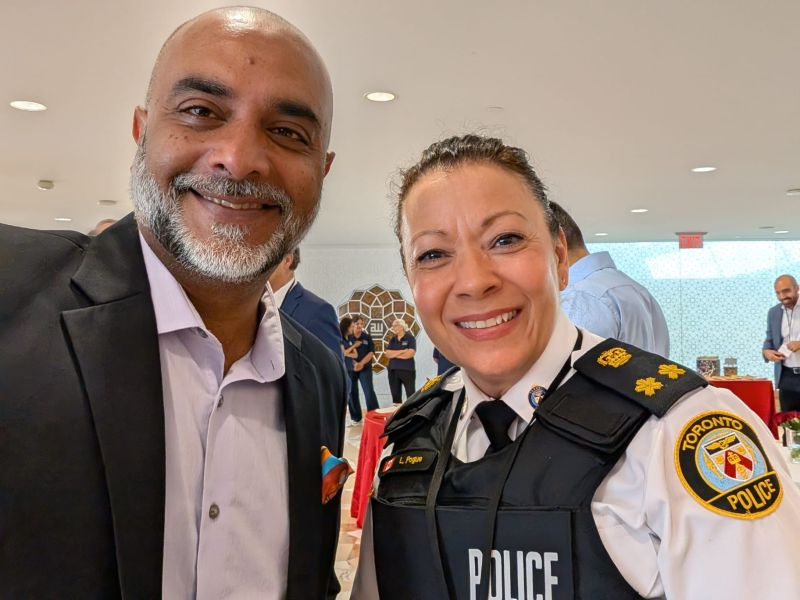Khurram Shroff with a Toronto Police officer at a community event